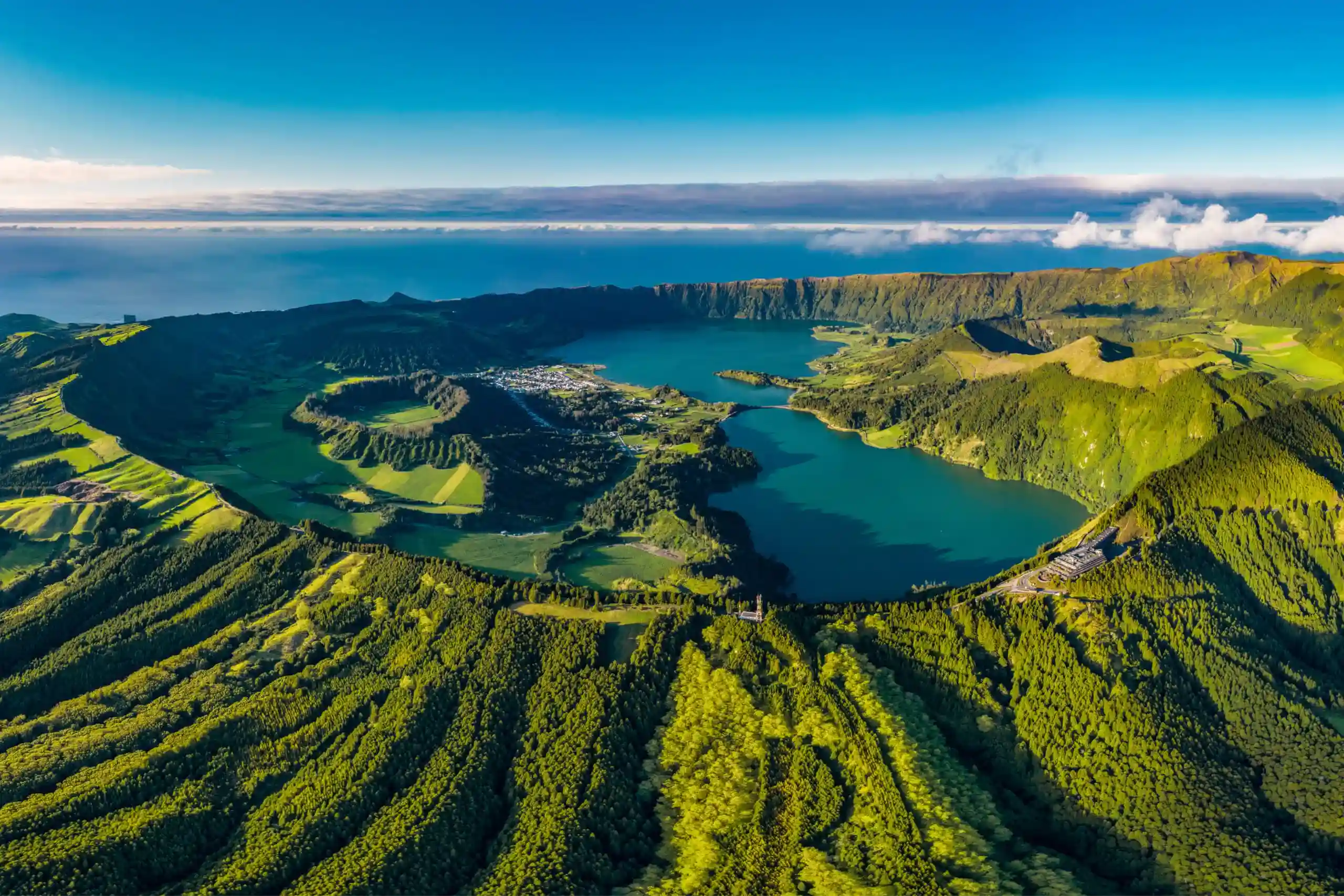 an aerial view of a lake surrounded by mountains