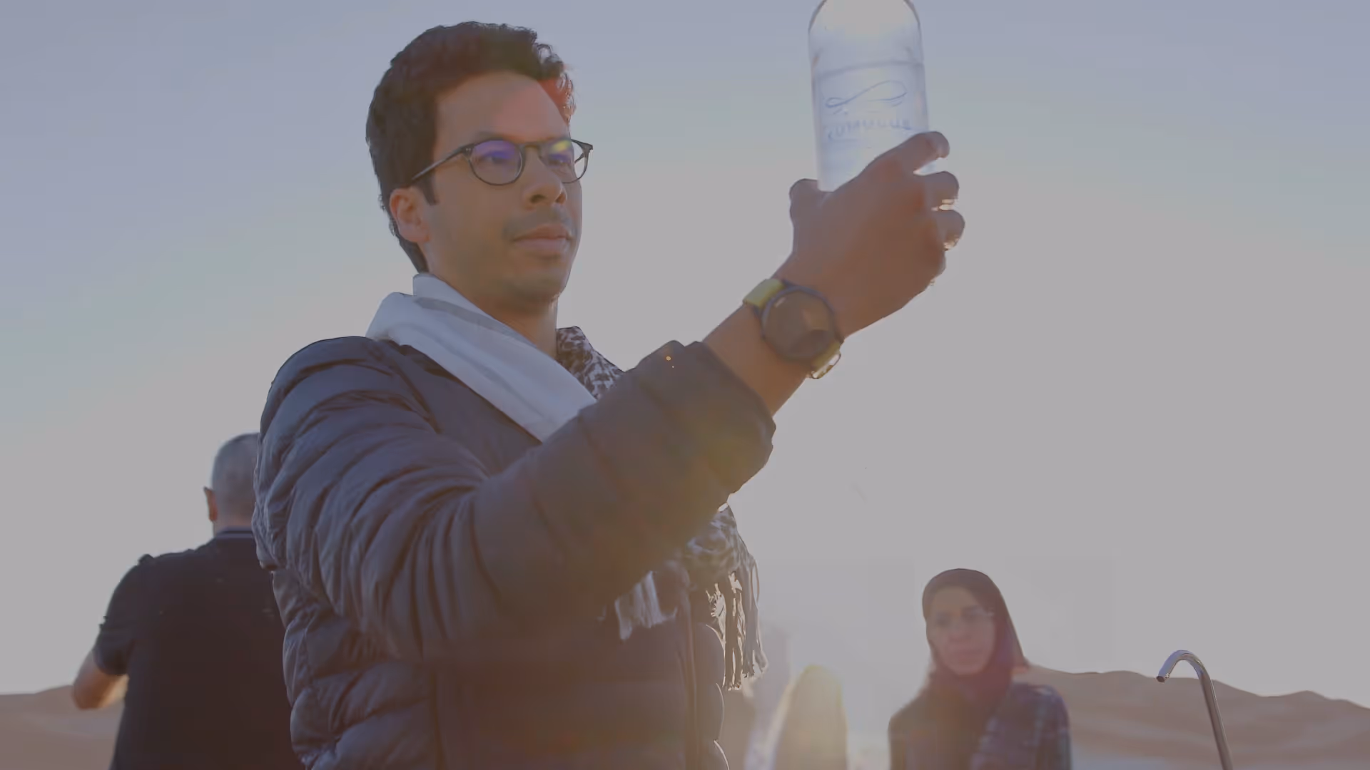 Iheb Triki, CEO of Kumulus Water, holding a bottle of water made from air.