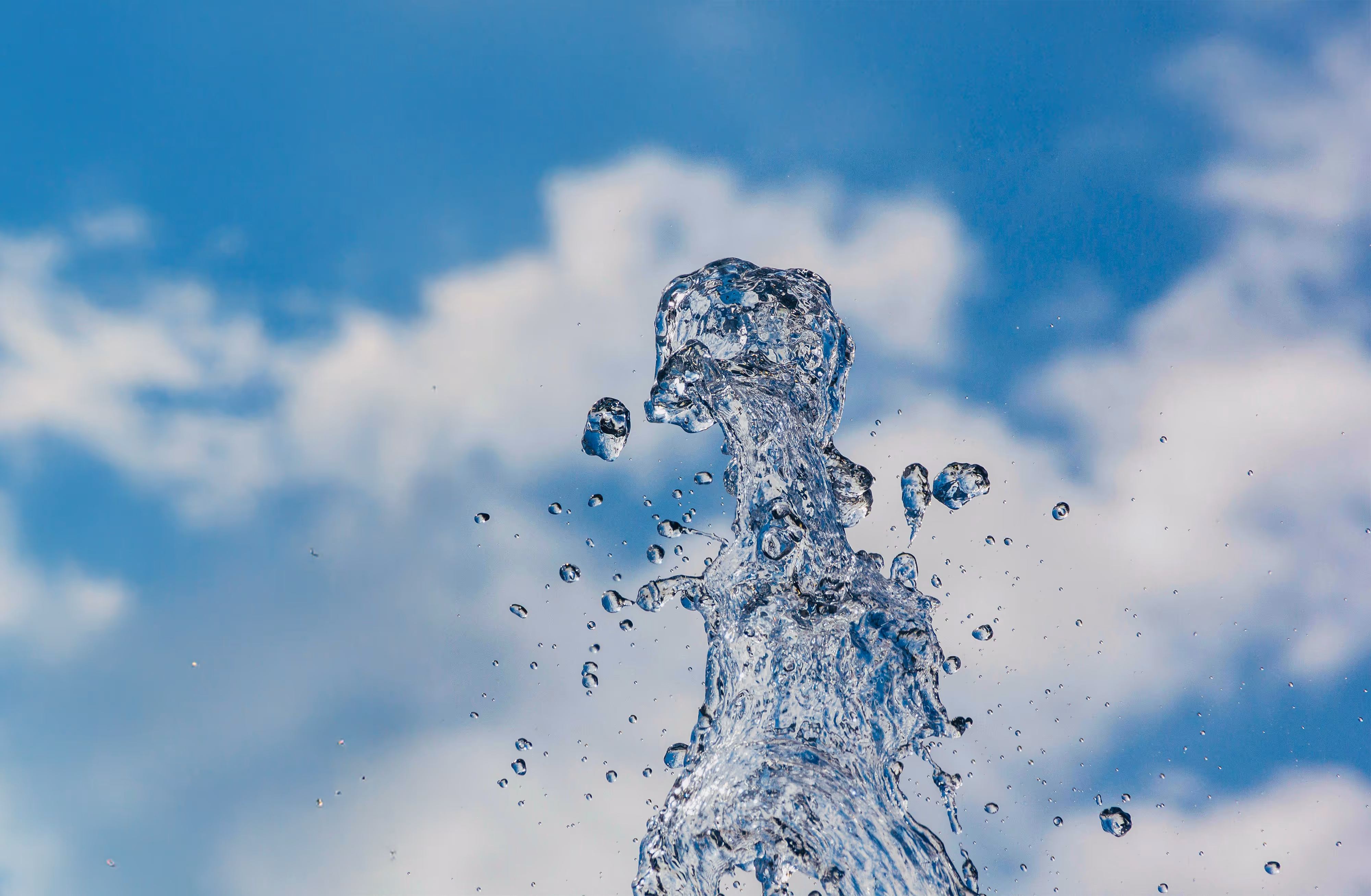 A splash of fresh water against the backdrop of a blue sky.