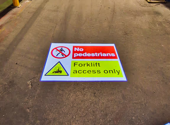 LED caution sign projection on industrial floor