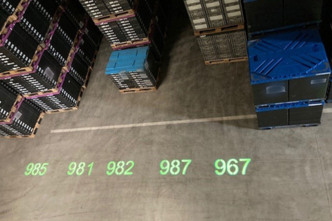 Bear Safety projection system mounted above warehouse aisle