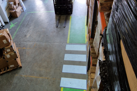 High-visibility projected crosswalk in logistics centre