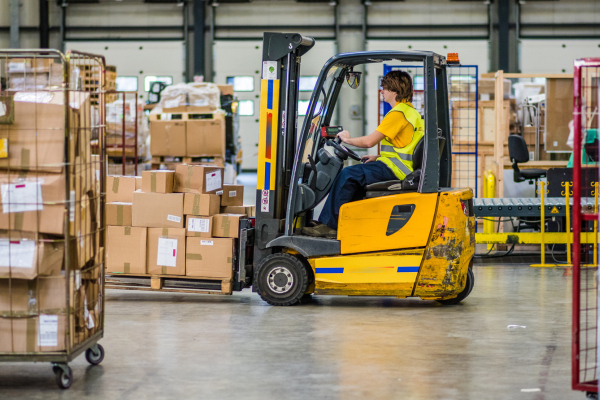 forklift driving through logistics facility