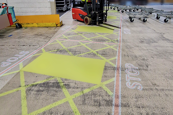 Projected path markings guiding workflow in automotive production line