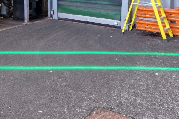 Clear green laser floor lines showing walkway through UK food facility