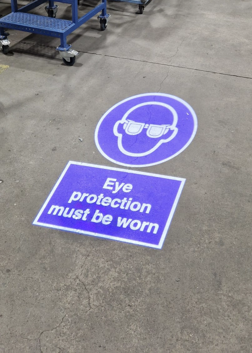 custom projected PPE signage saying eye protection must be worn