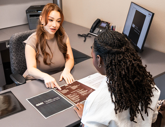 SMI staff member supporting prospective aesthetics students