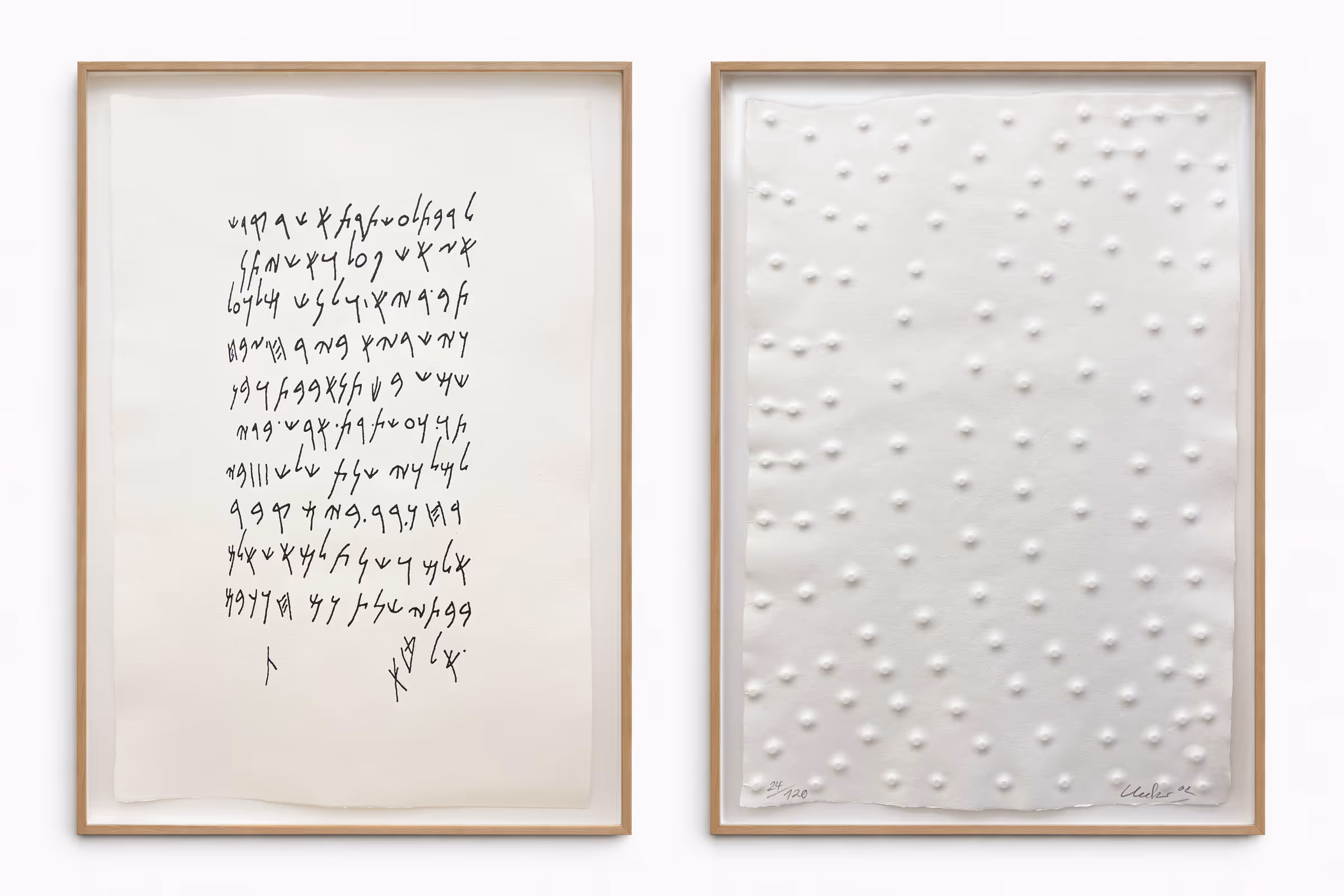 Zwei gerahmte Kunstwerke nebeneinander: links ein Blatt mit handgeschriebenen, schwarzen, kalligraphischen Zeichen; rechts ein weißes Relief mit gleichmäßig verteilten, erhabenen Punkten.