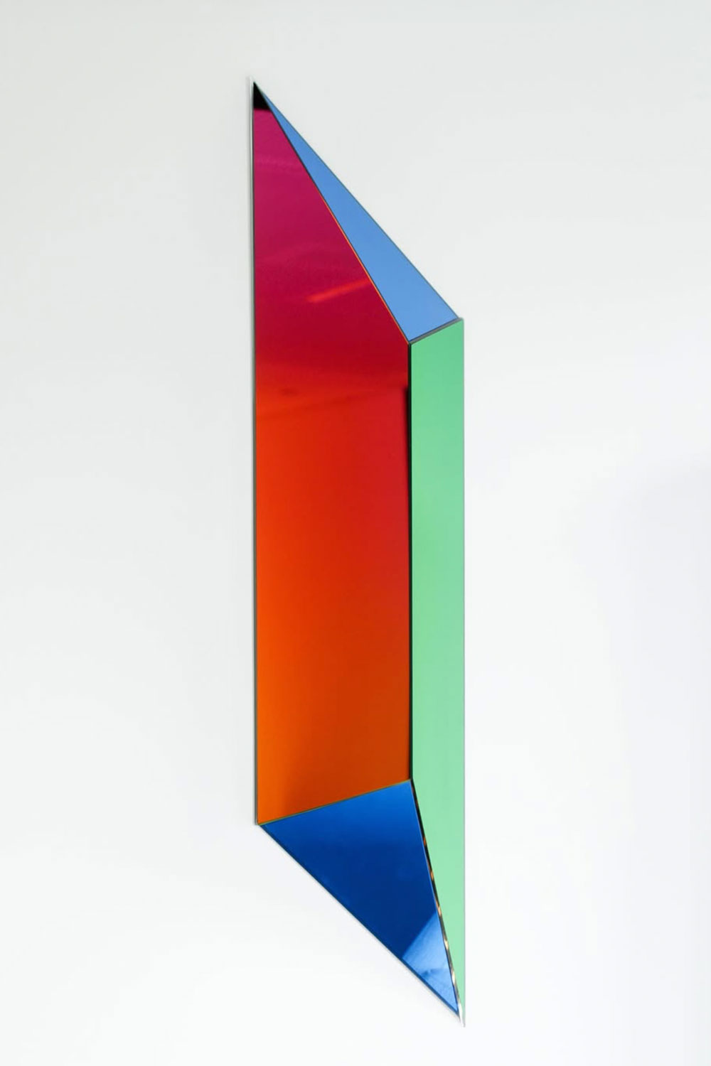 Dreieckige, bunt reflektierende Wandkunst mit blauen, grünen, roten und orangen Flächen.
