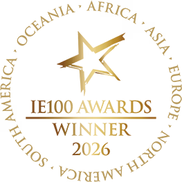 IE100 Award 2026 gold emblem with a star and laurel wreath design.