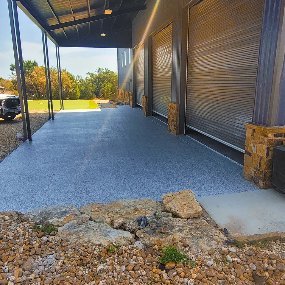 Garage conversion with slip-resistant concrete flooring and decorative stone brick walls