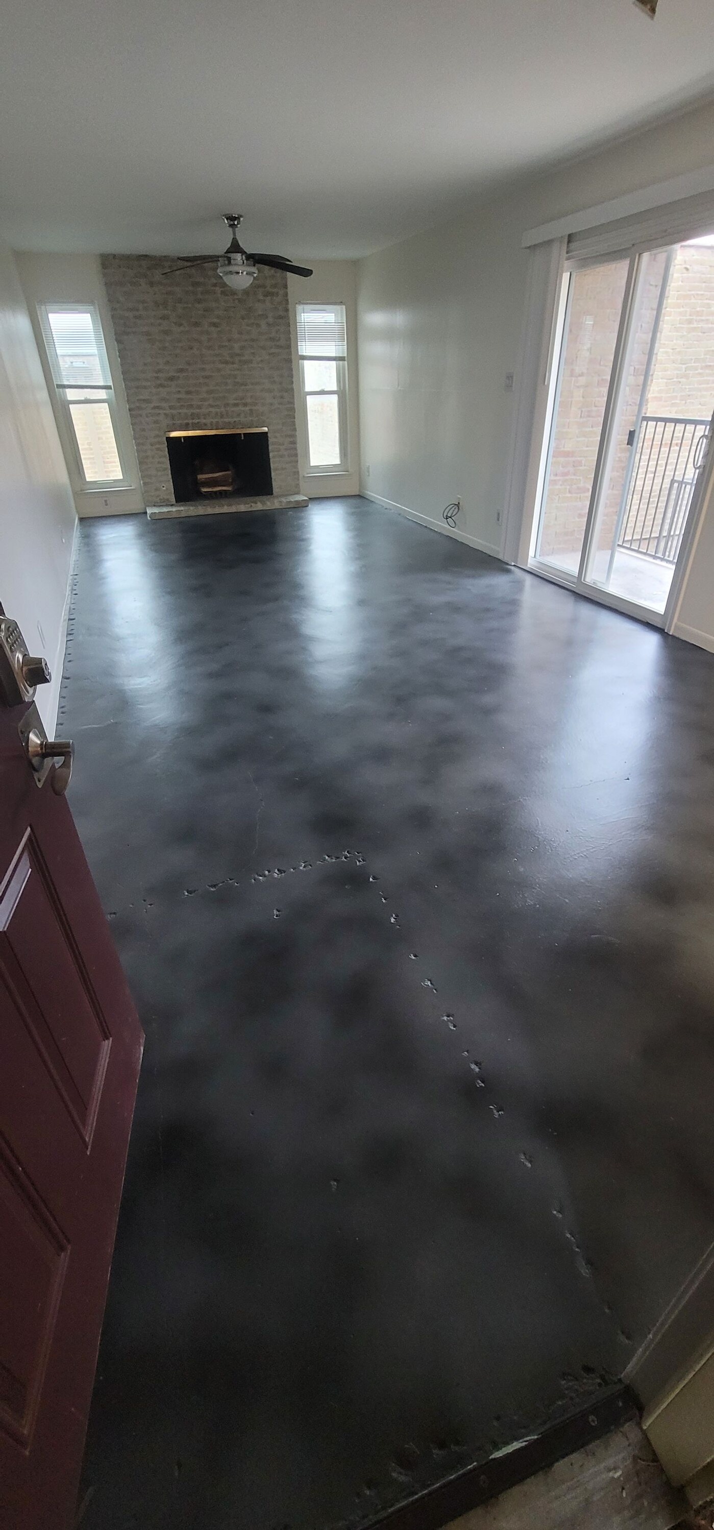 Contemporary home with matte concrete floors and a fireplace