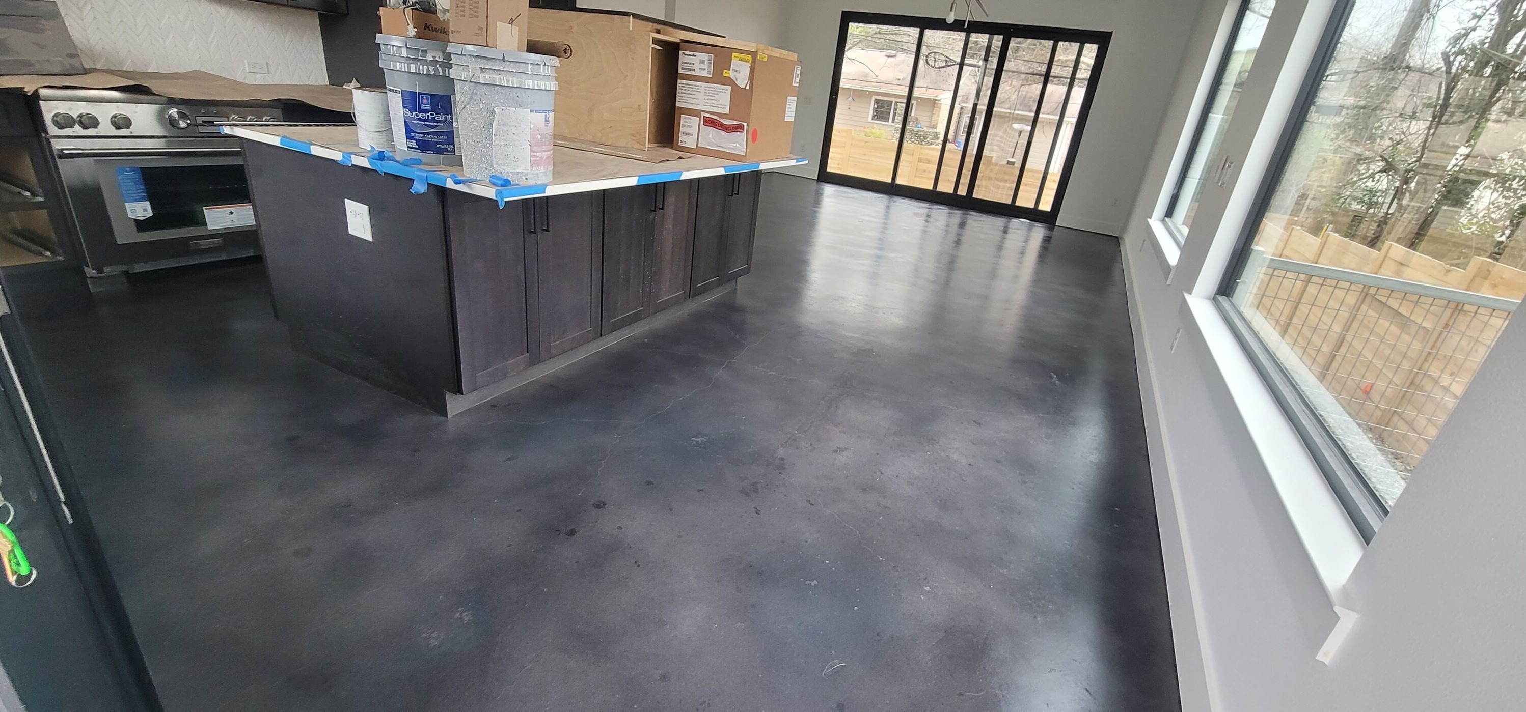 Modern living room with polished concrete floor and natural wood walls
