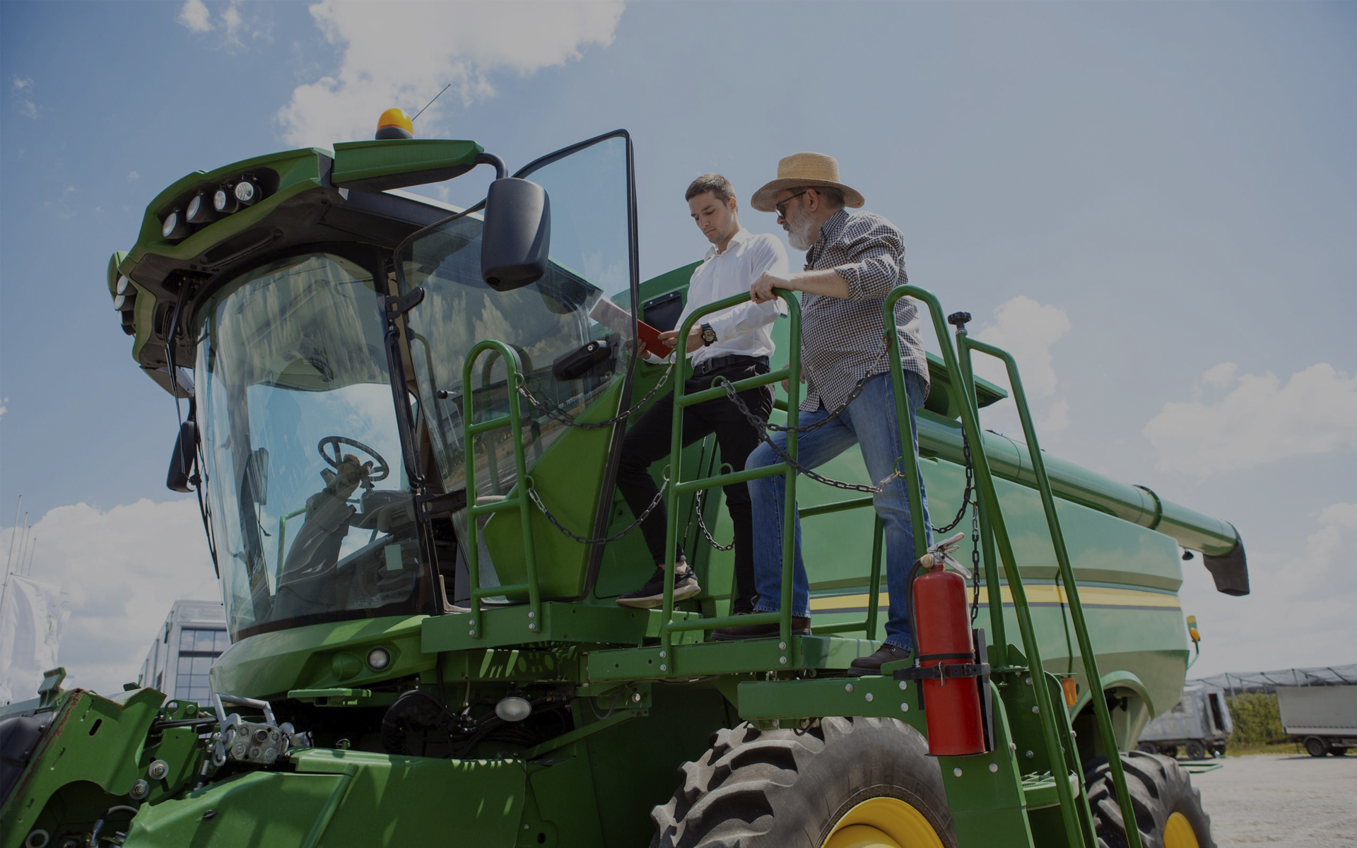 Handsome young man in orange classes on clear sky background.