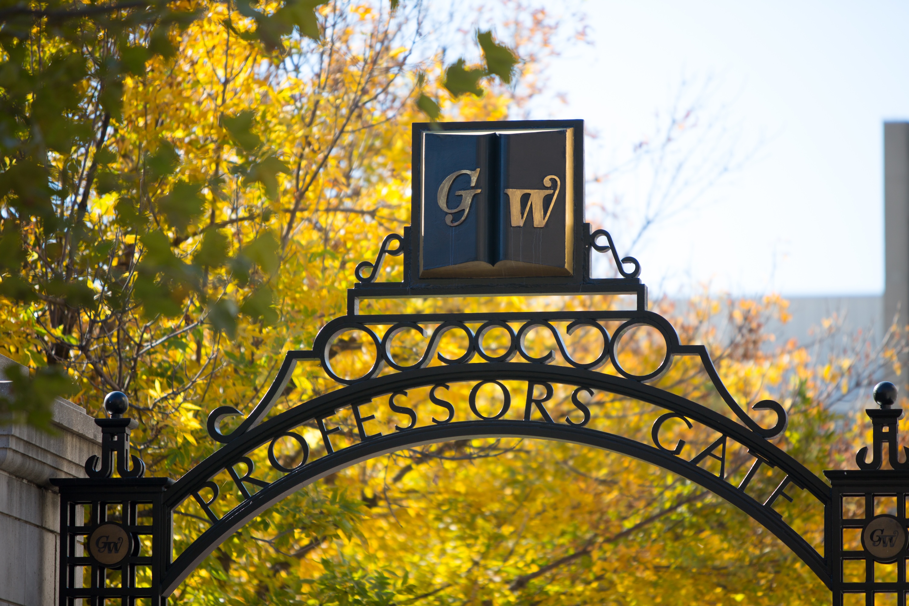 Professors Gate at George Washington University framed by autumn foliage.