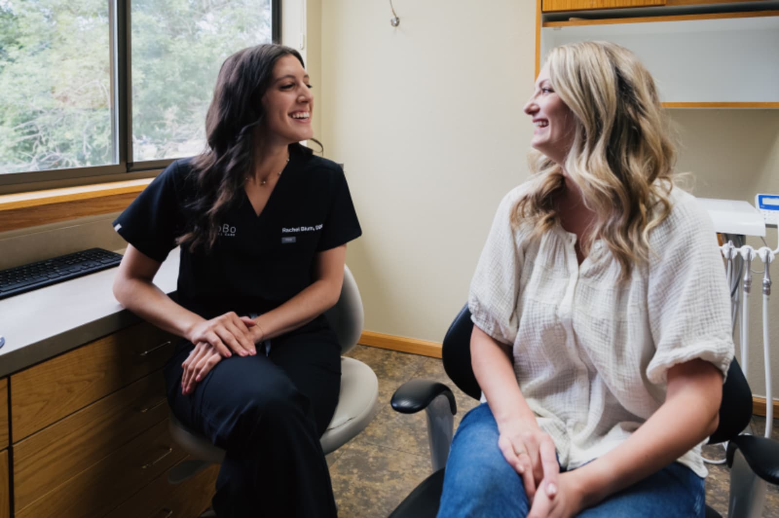 Dentist consulting with patient in treatment room during crown consultation