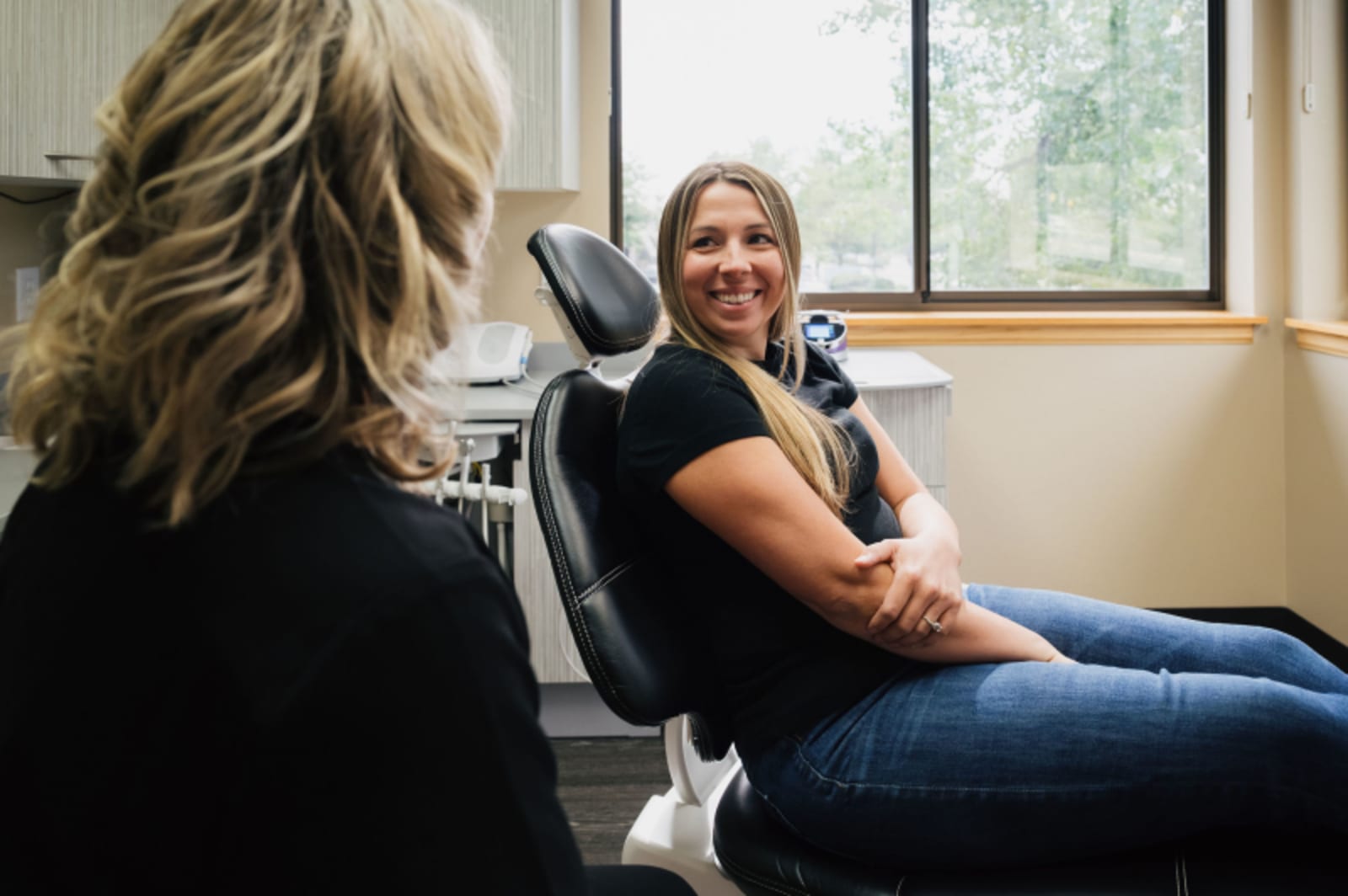 Patient in dental chair speaking with female dentist during consultation at SoBo Dental Care.