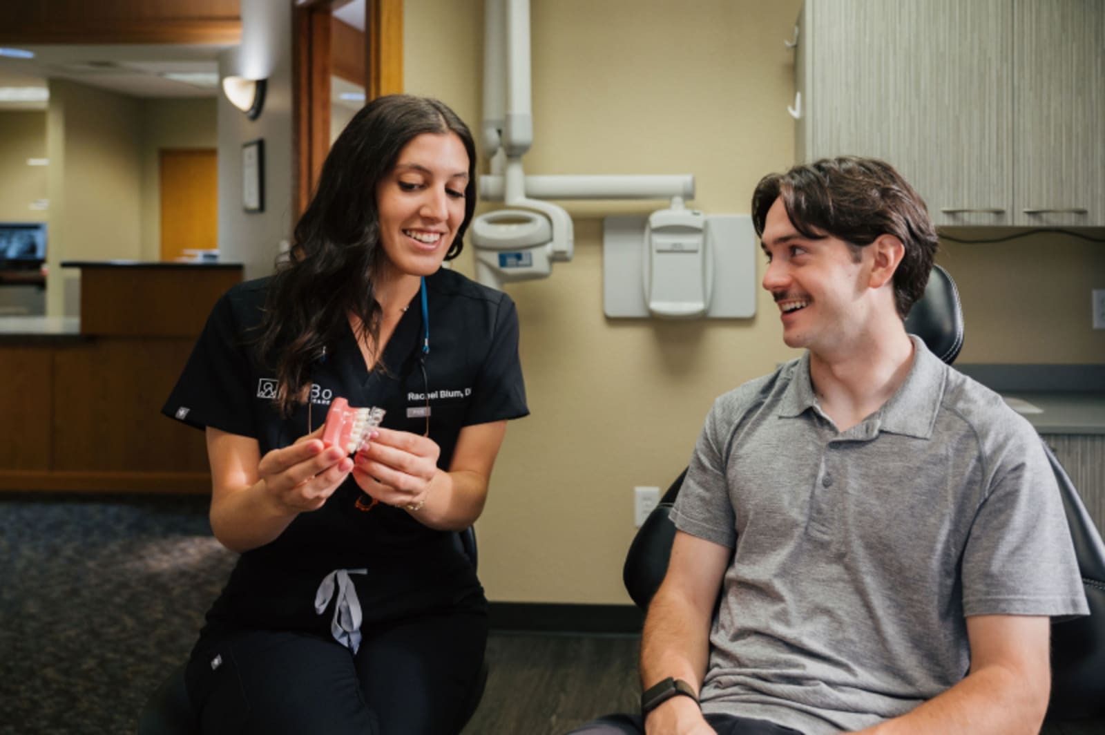 Team member consulting with patient in treatment room during initial visit