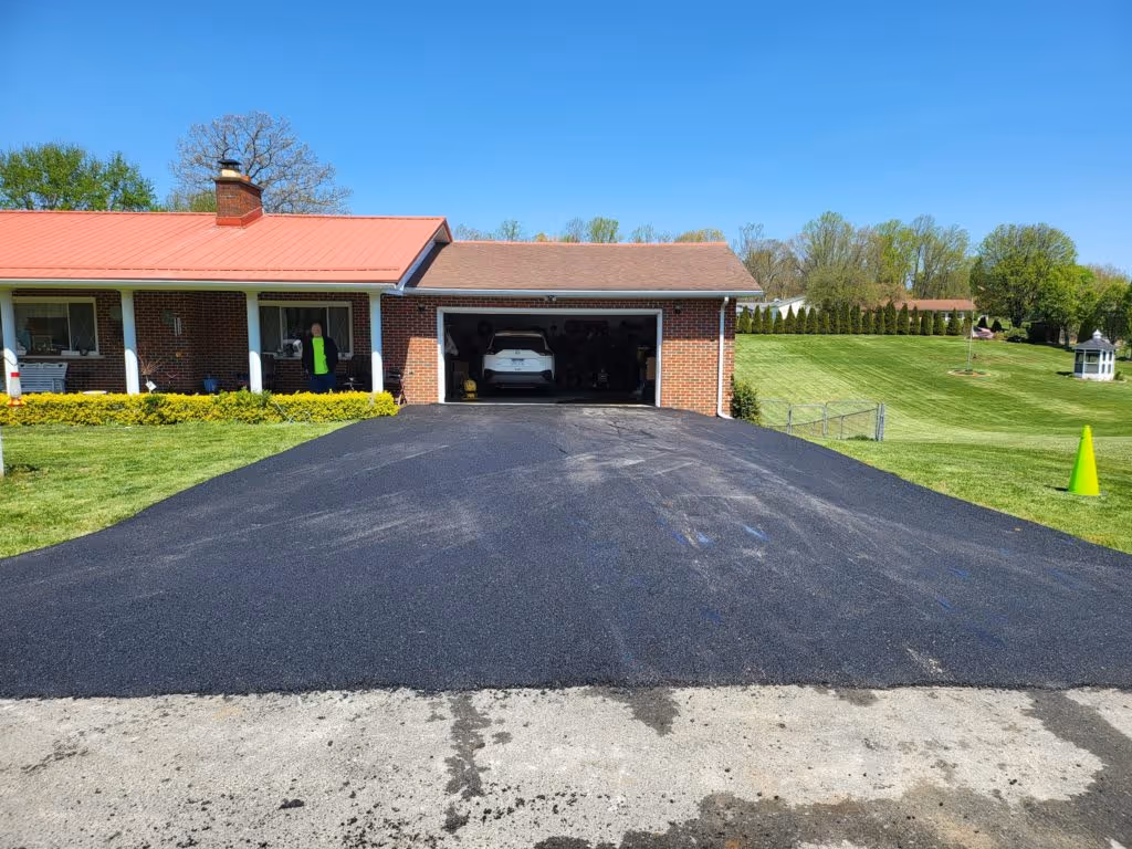 A newly paved driveway in front of a home.