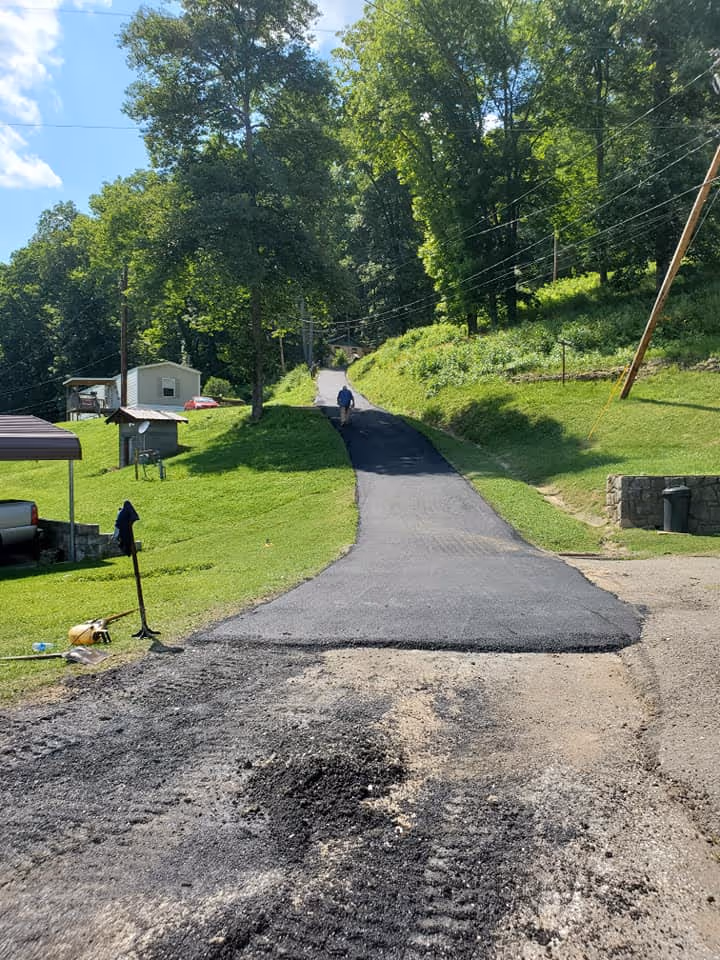 A freshly paved access road leading up to a home