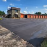 A newly paved parking lot outside of a storage facility.