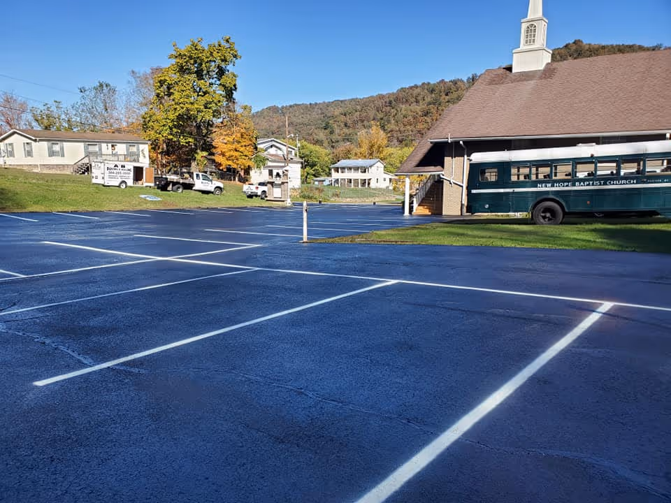 A newly paved and striped parking lot outside of a church.