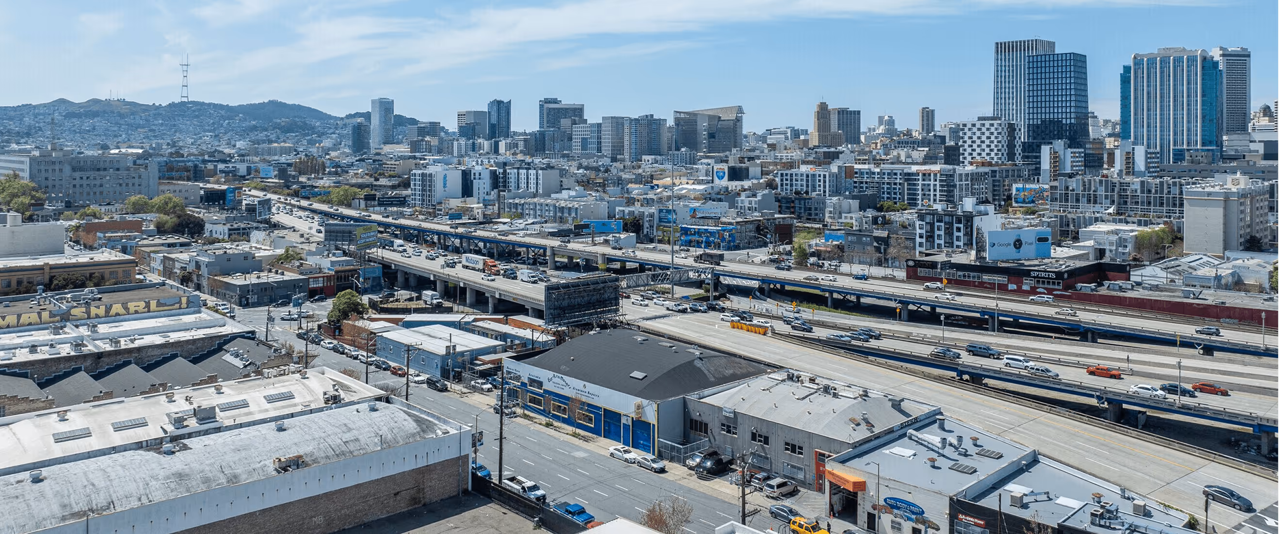 An aerial view of a city with a train on the tracks.