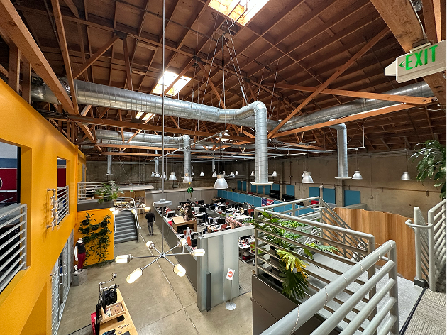 A large open building with lots of tables and chairs.