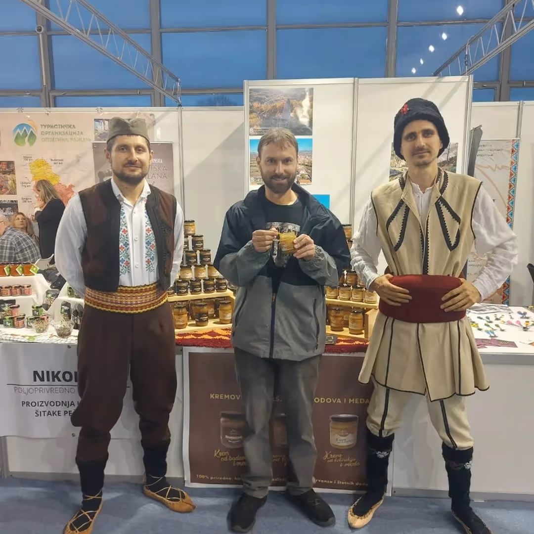a group of men standing in front of a table with drinks