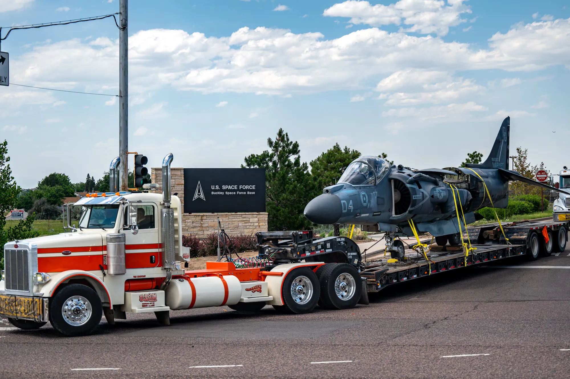 Plane being hauled on flatbed truck