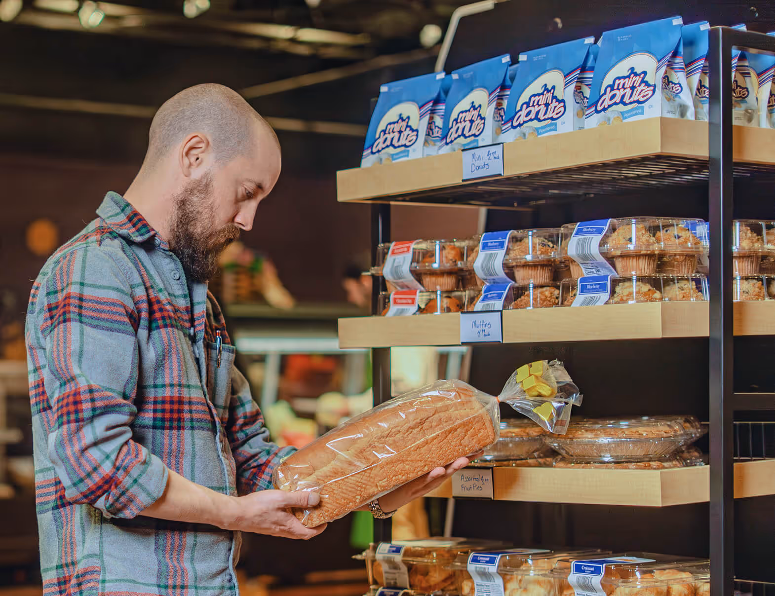 Man grabbing bread from a hubert shelf