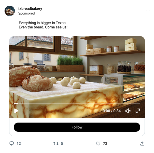 A person in an apron working at a table with bottles and a laptop.