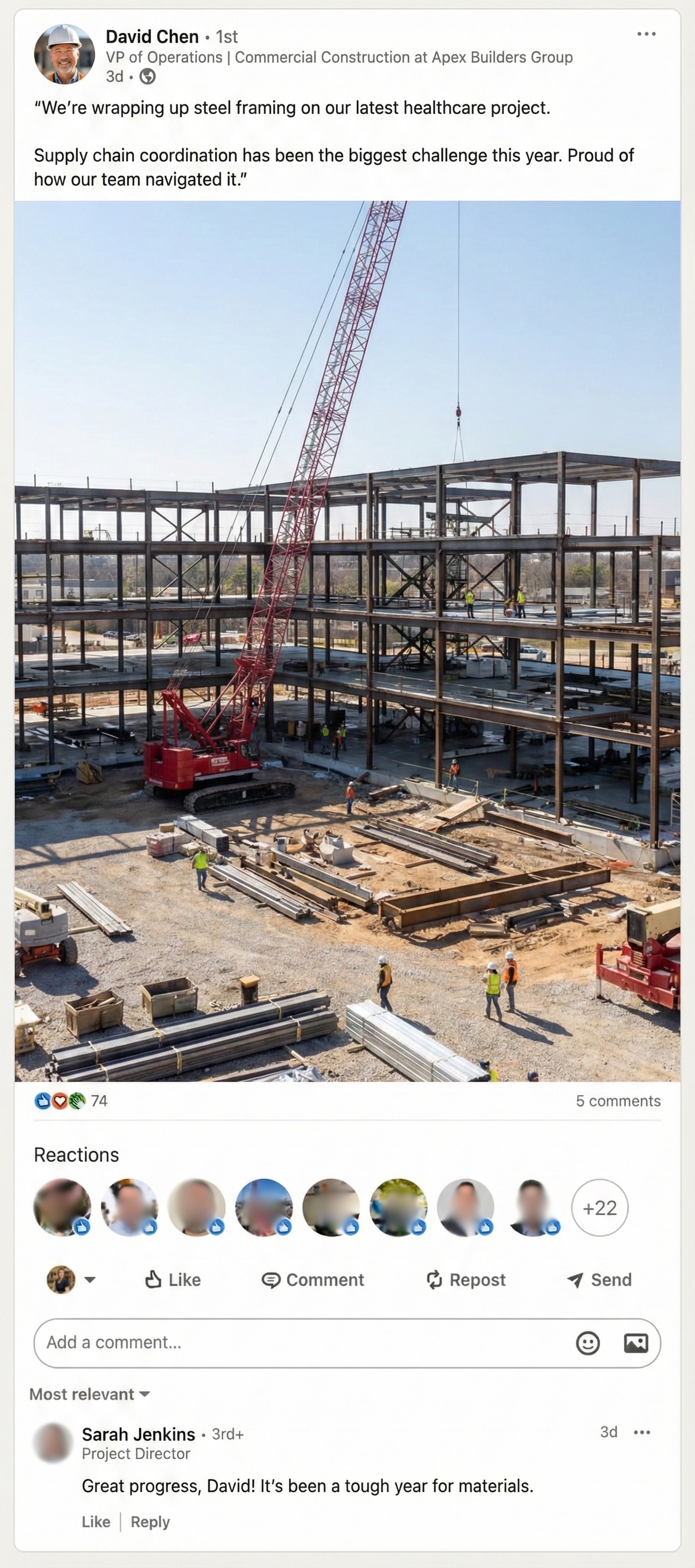 A hiker in a red jacket standing in a mountainous desert landscape.