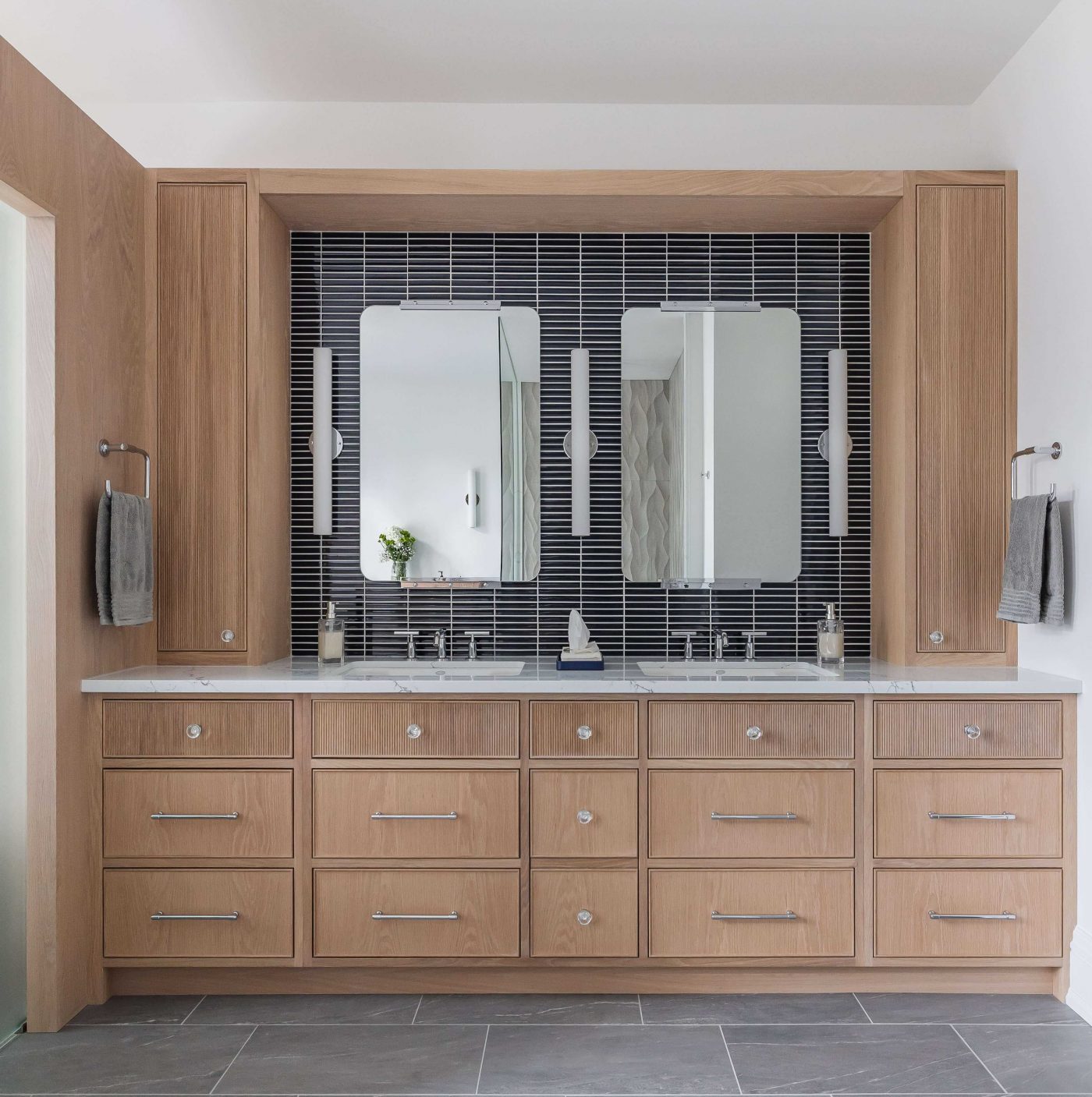 The crystal knobs add a touch of elegance to the reeded drawers.