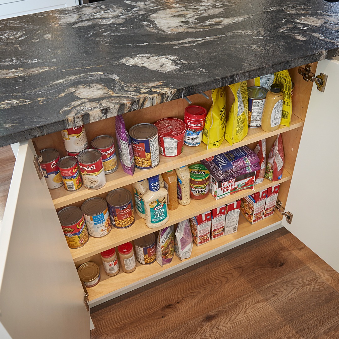 Shallow, hideaway cabinet is tucked behind push-latch doors within the island.