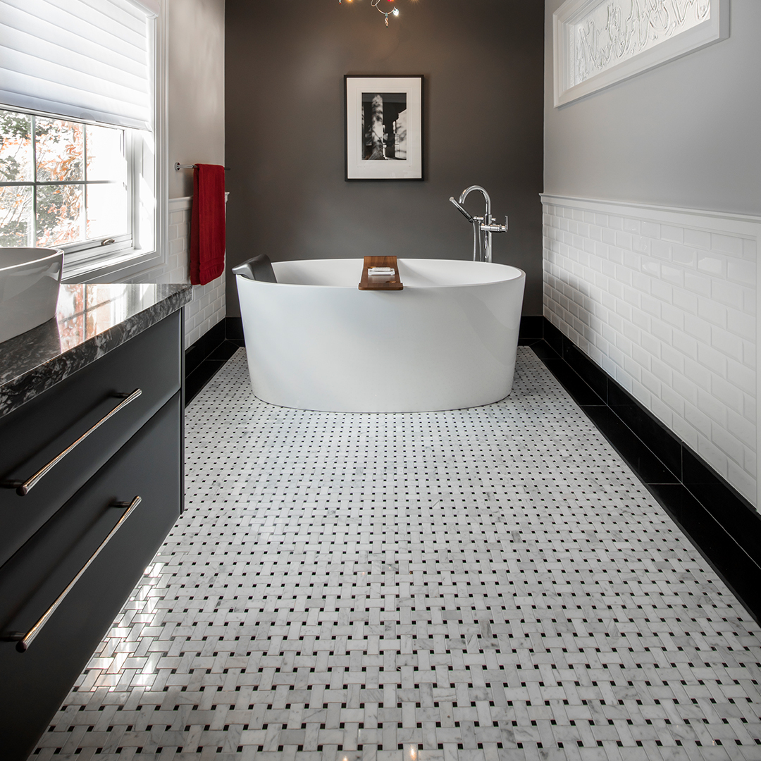 Delicate and intricate titles lead the way to a single standing tub that invites anyone in need of relaxation.