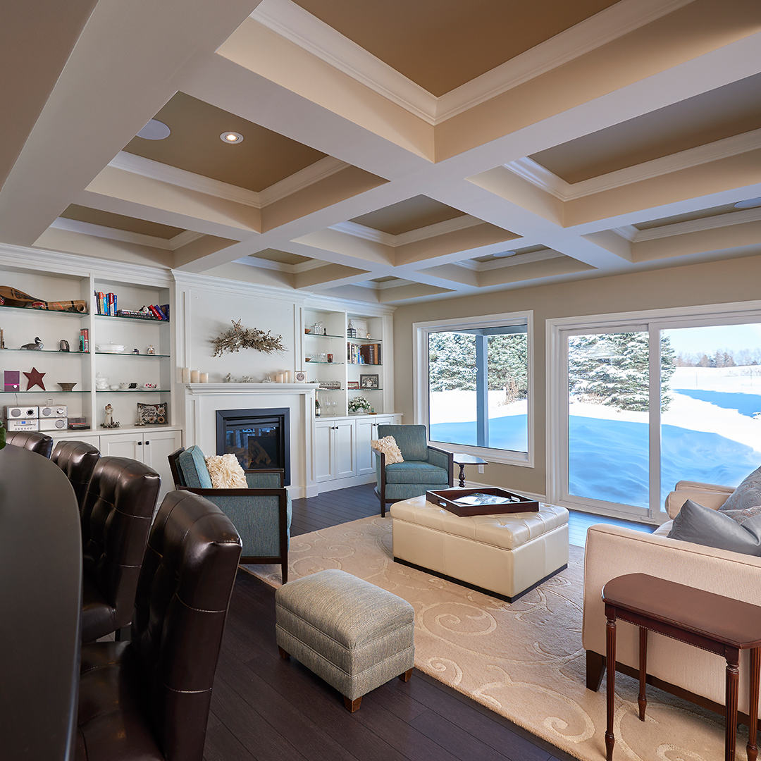 The fireplace is flanked by floor to ceiling custom cabinets.