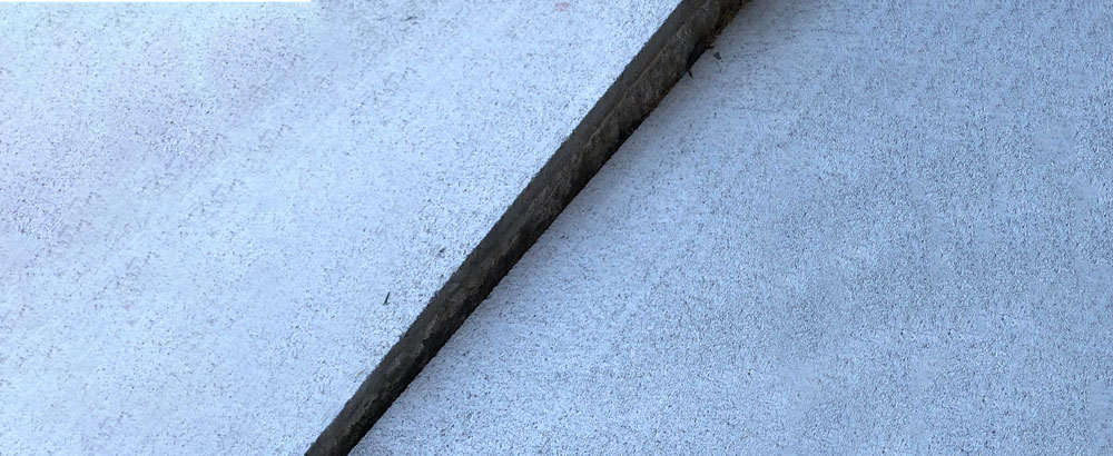 A before image of uneven concrete.