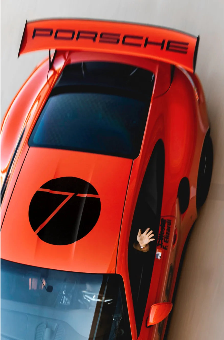 a red sports car with a person sticking their head out of it