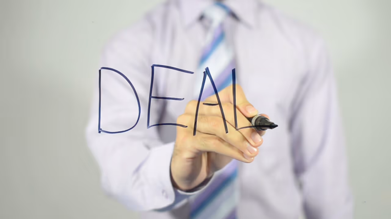 Lawyer writing DEAL on glass with marker