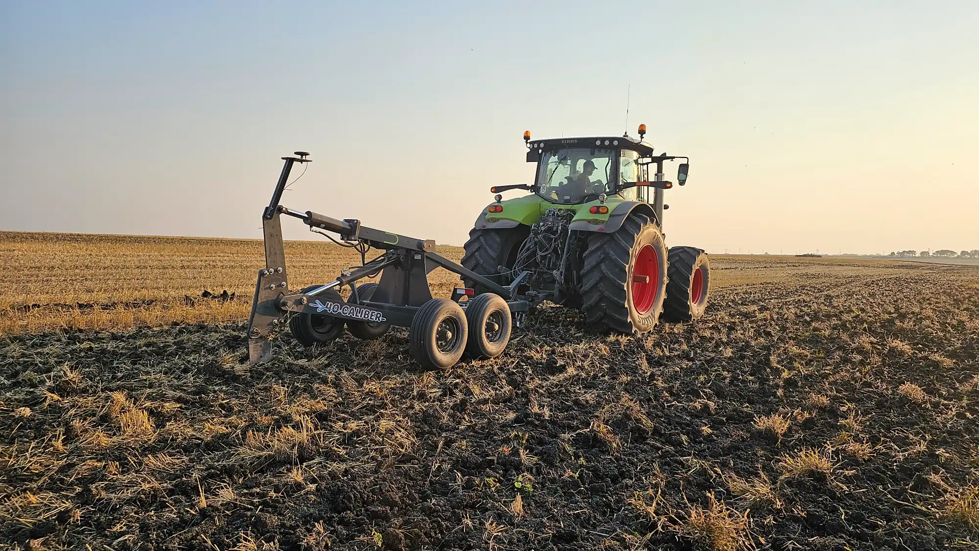 Mole Plow behind tractor during spring installation