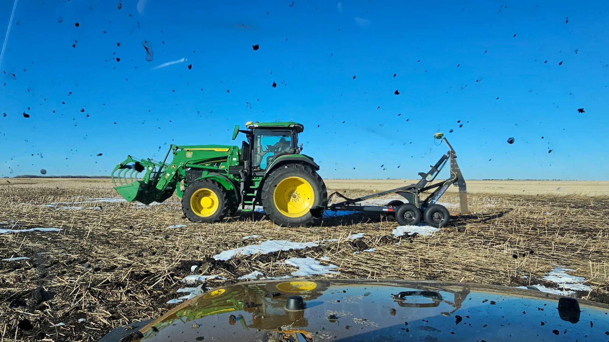 Mole Plow installing sub-surface drainage with some snow on the ground