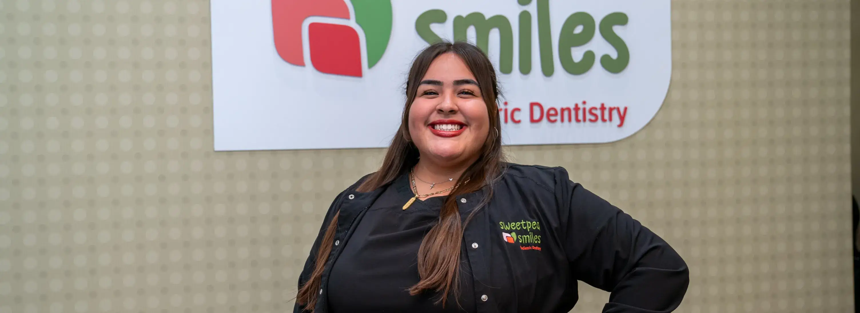 a woman standing in front of a smile clinic sign