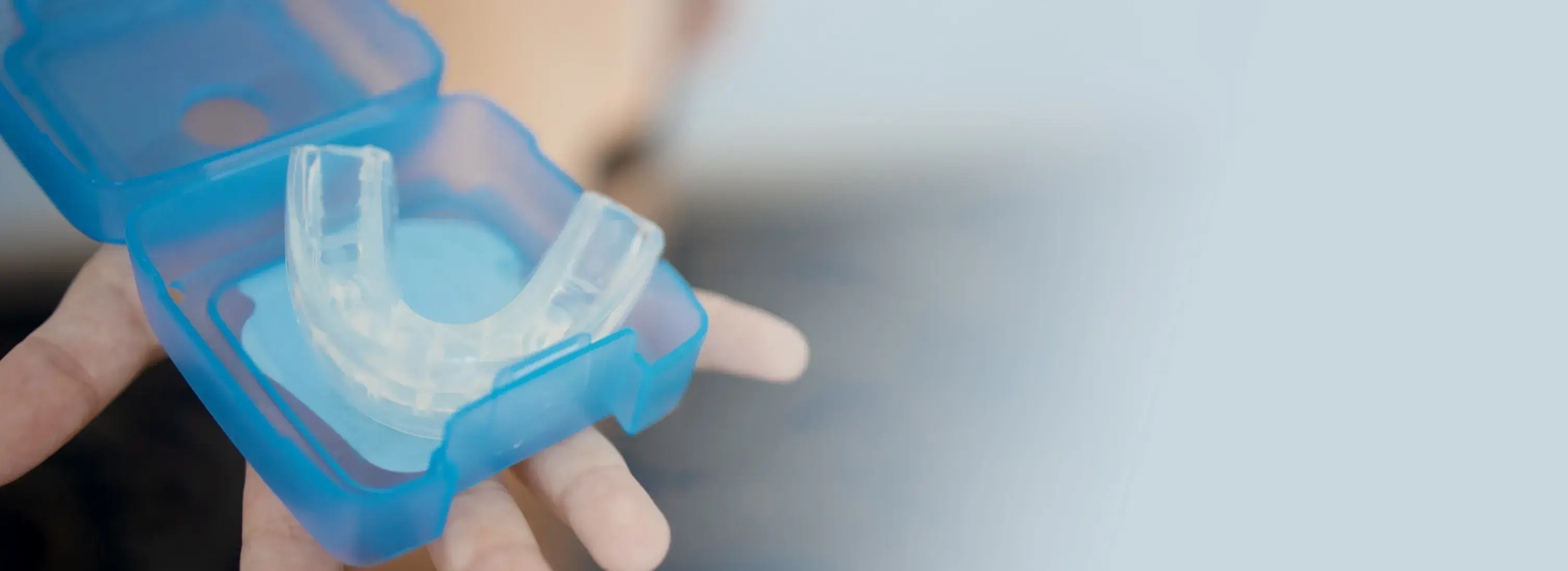 a person holding a plastic object in their hand