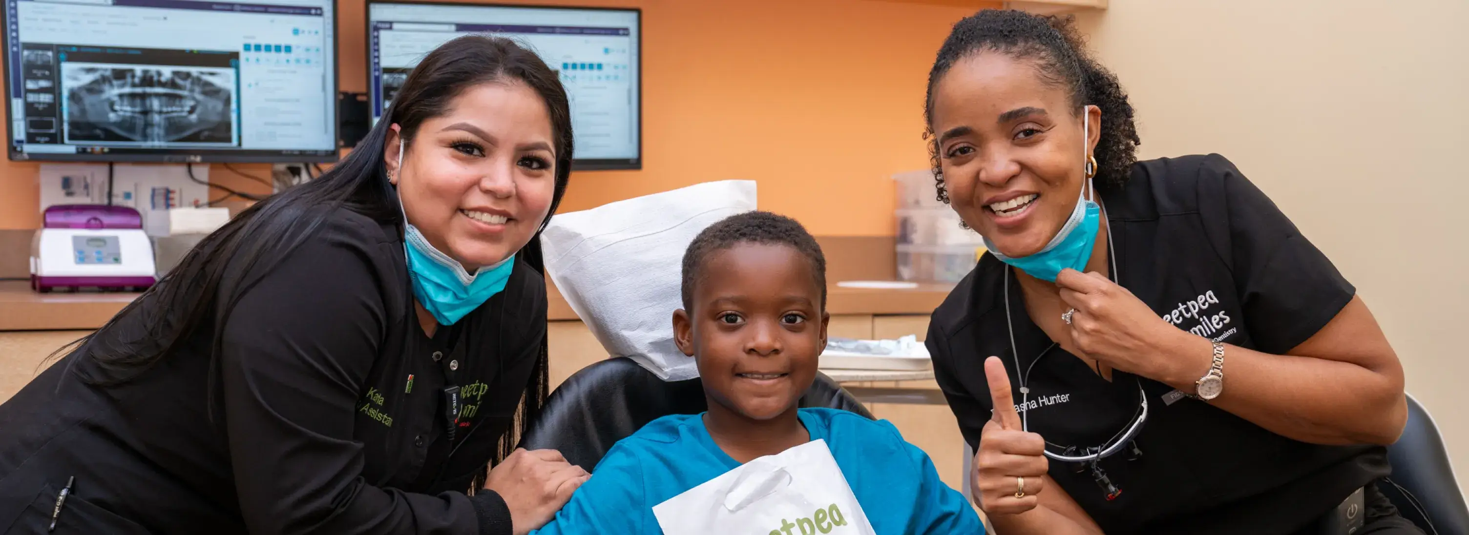 two women and a boy are smiling for the camera