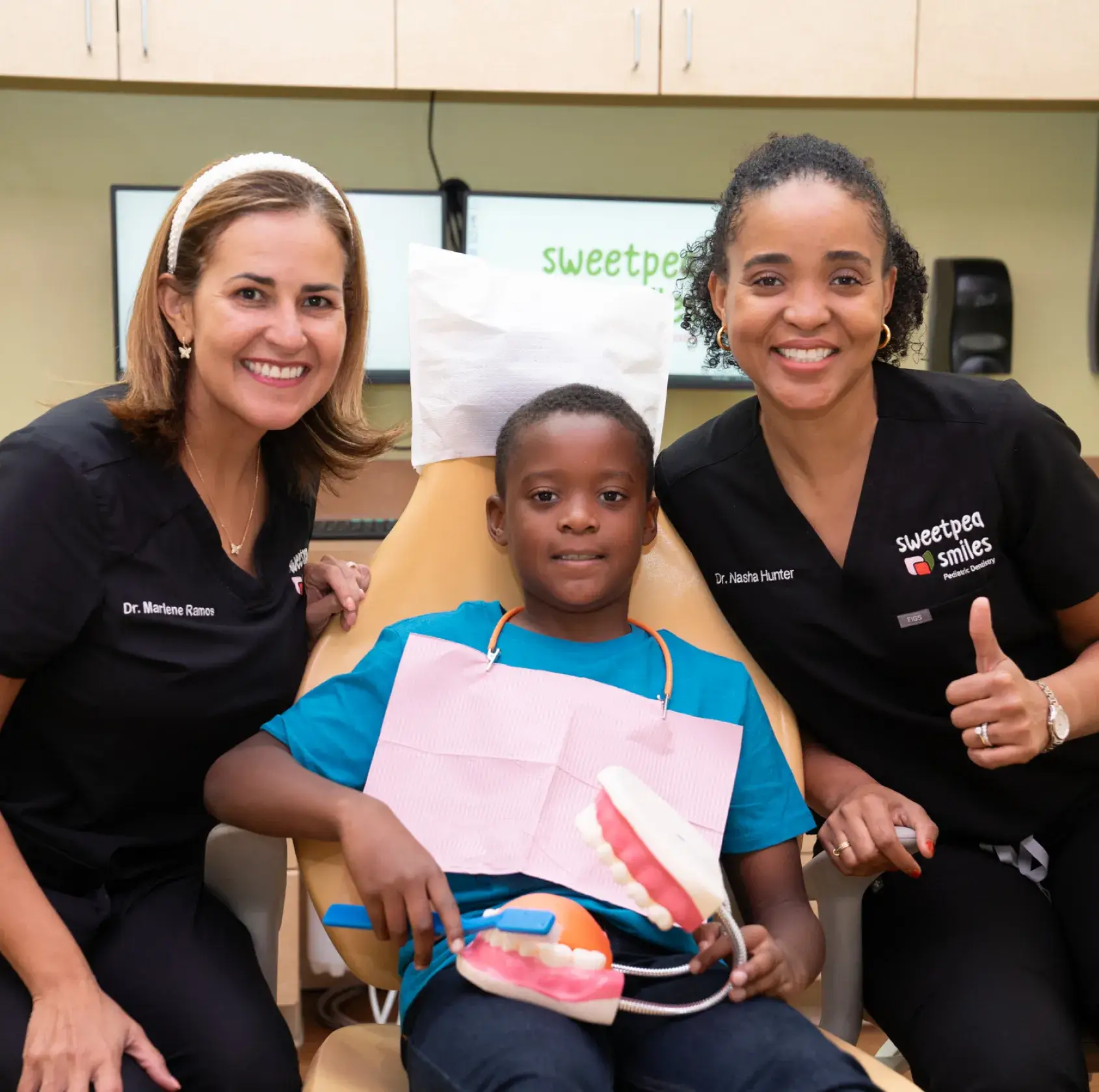 two women and a boy sitting in a chair