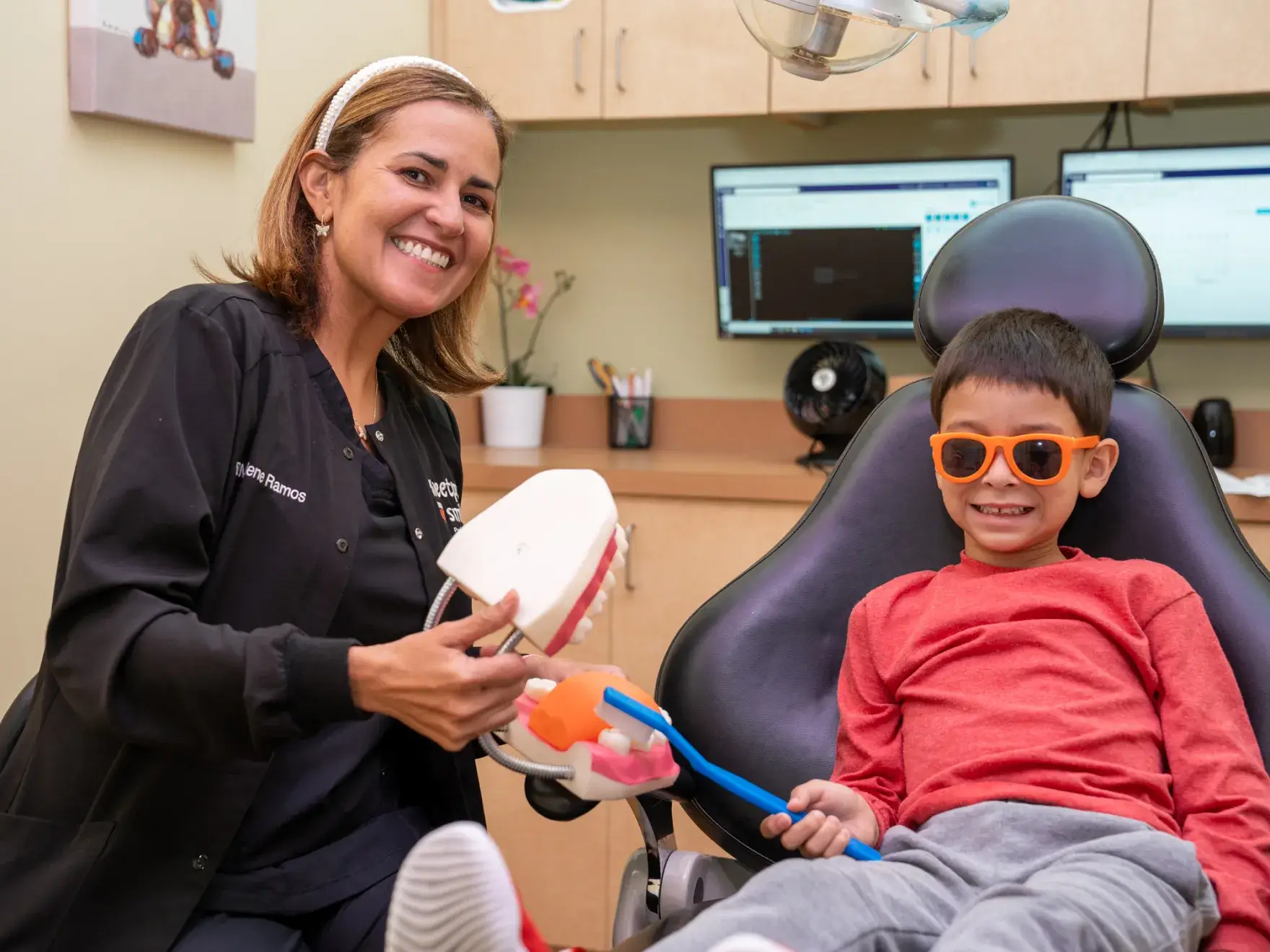 a young boy is sitting in a dentist chair