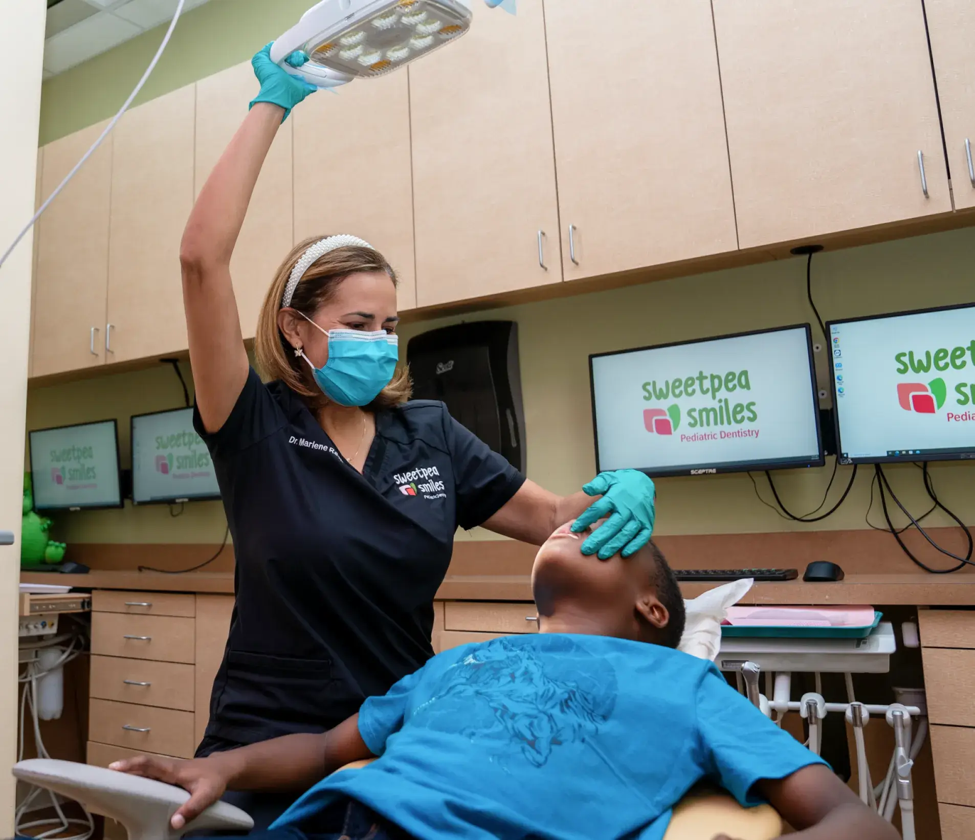 a person in a dentist chair with a mask on