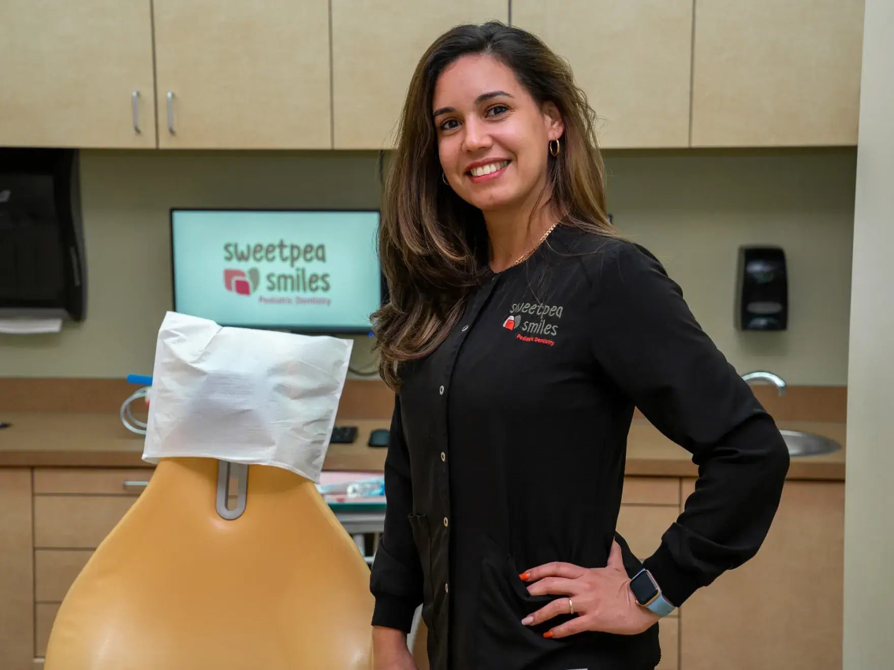 a woman standing next to a dummy in a dentist's office