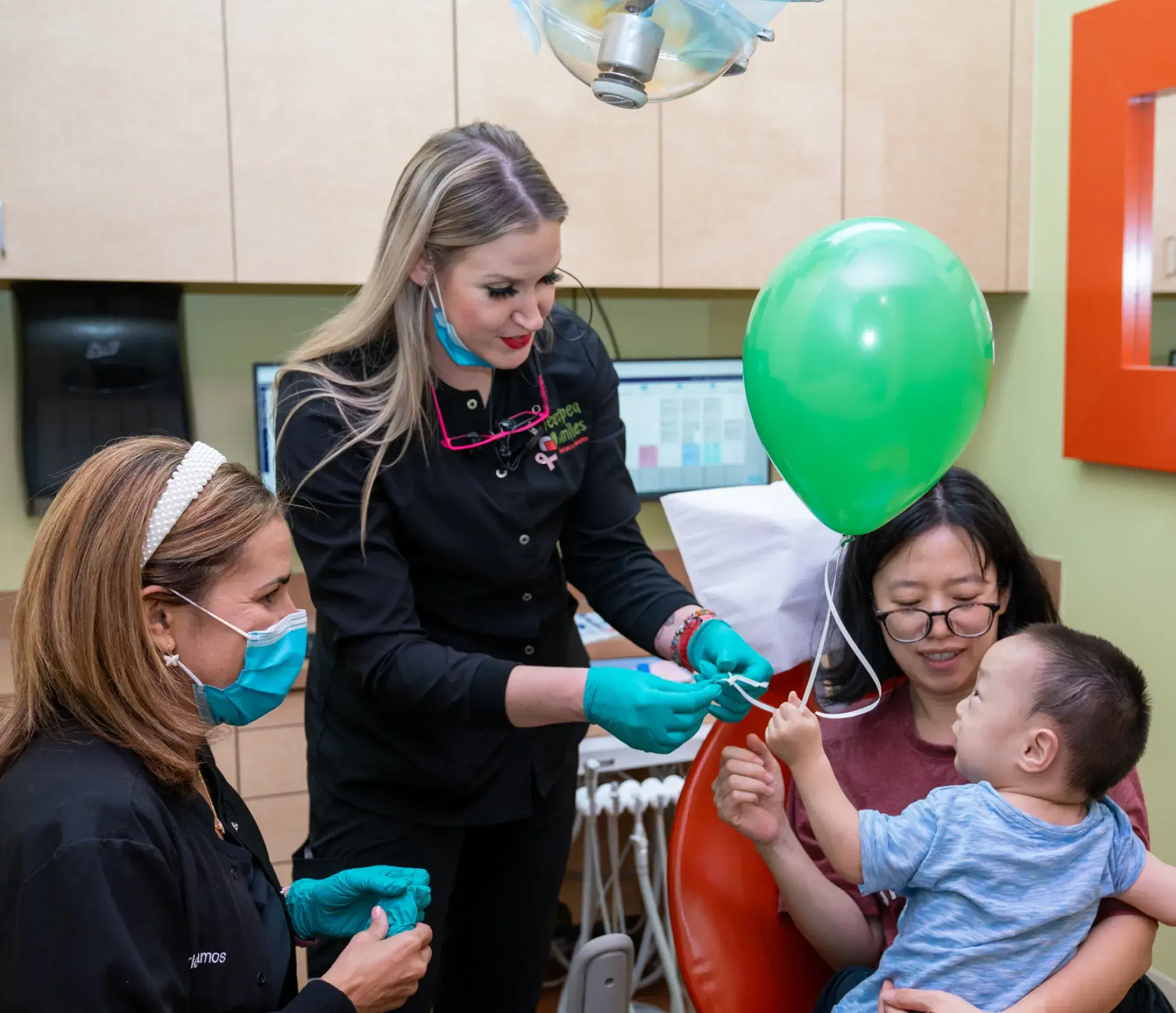 a group of people in a room with balloons
